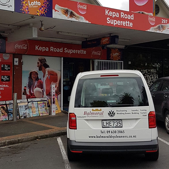 Gray Car in front of the Balmoral Drycleaners Store